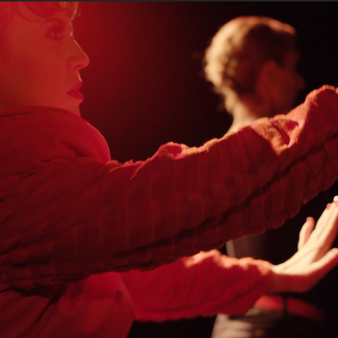 A still from the video for Fade Away featuring Dyan Valdés and another dancer mid movement